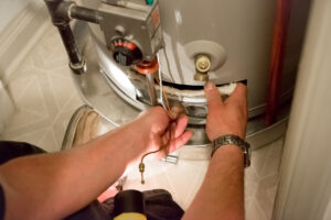 Technician repairing a water heater not working